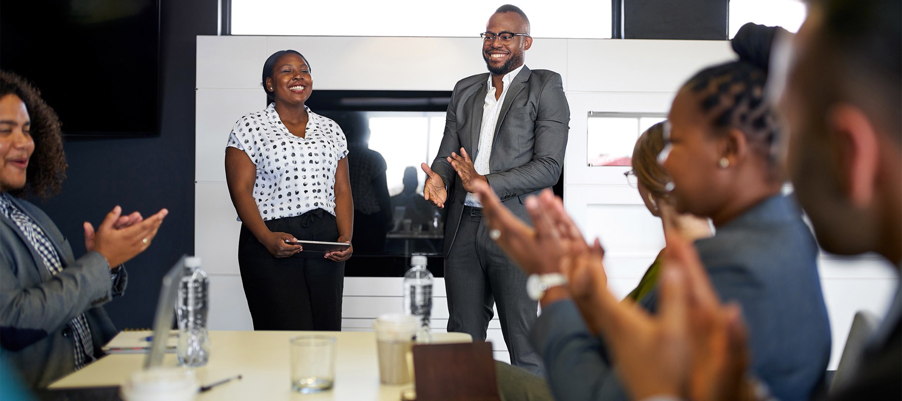 People in a meeting room around a table