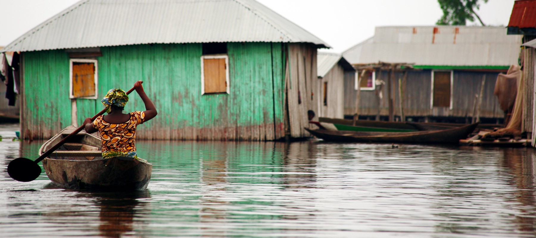 Boat moving between houses during a flood