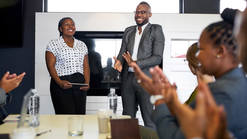 People in a meeting room around a table