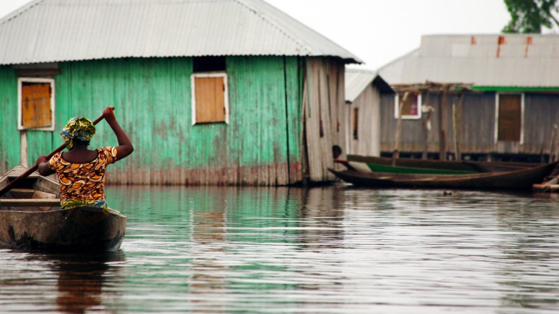 Boat moving between houses during a flood