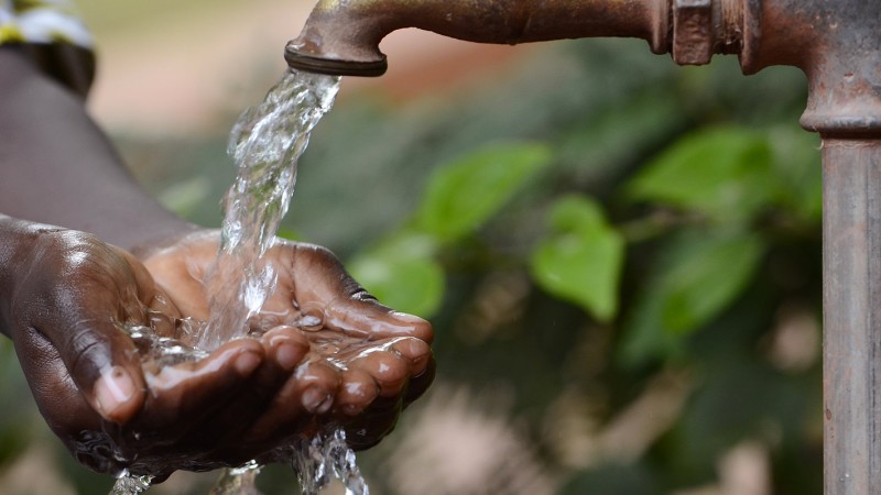 Hands being washed from a tap