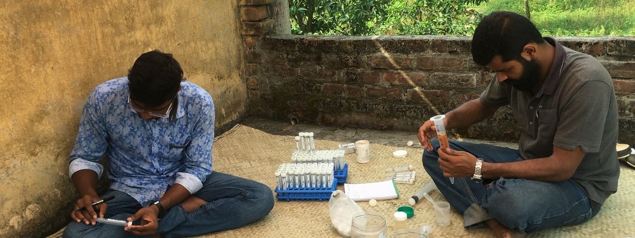 Two men testing the quality of water